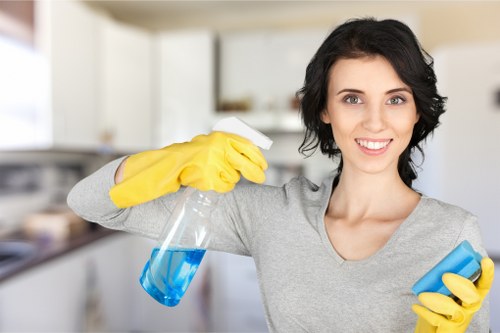Technician applying odour neutralising treatment to carpet fibres